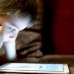 young child using a tablet device
