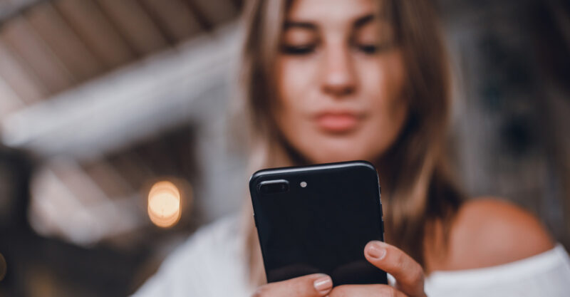 Photo of woman using smart phone.