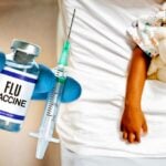 flu vaccine and child in hospital bed