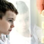 boy staring out window and word "plan"