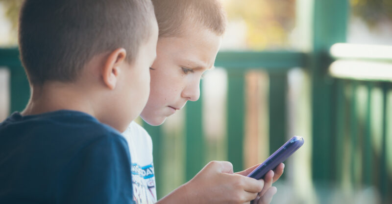 Young children playing on smartphone