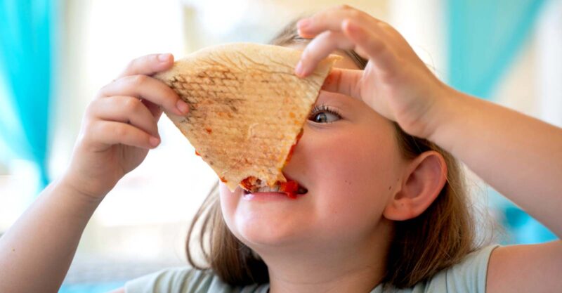 girl eating pizza