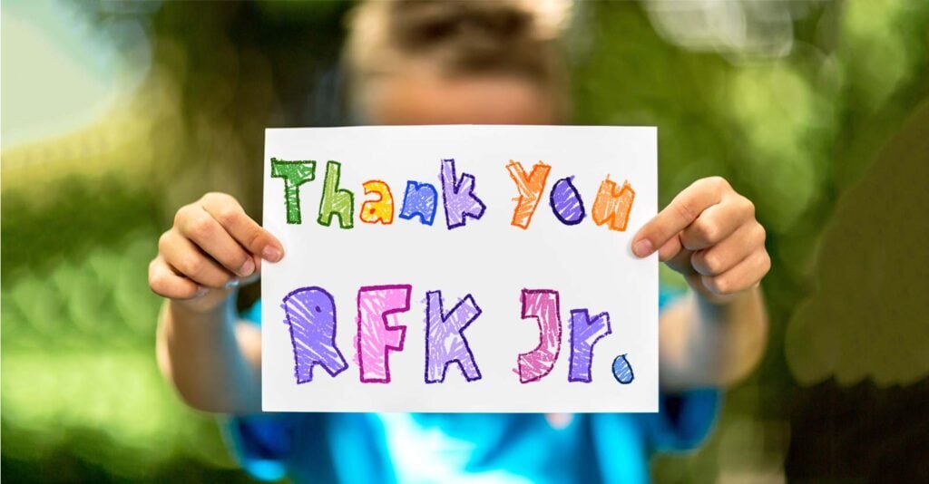 child holding paper that reads "Thank You RFK Jr."