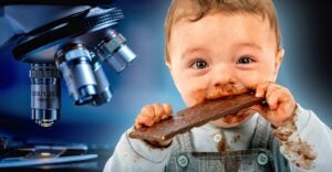 child eating chocolate bar and a microscope