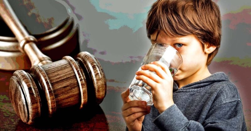 gavel and young boy drinking water