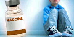 boy's feet and vaccine bottle
