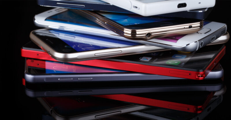 Multiple smartphones stacked on top of each other.