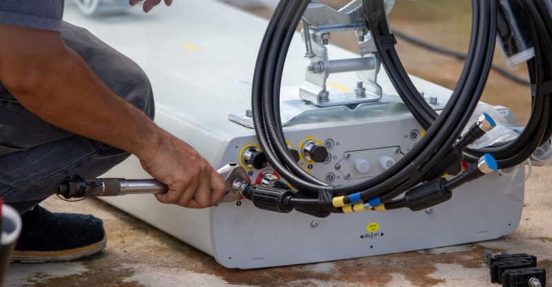 Photo of worker installing 5g Antenna.