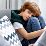child being screened by adult taking notes