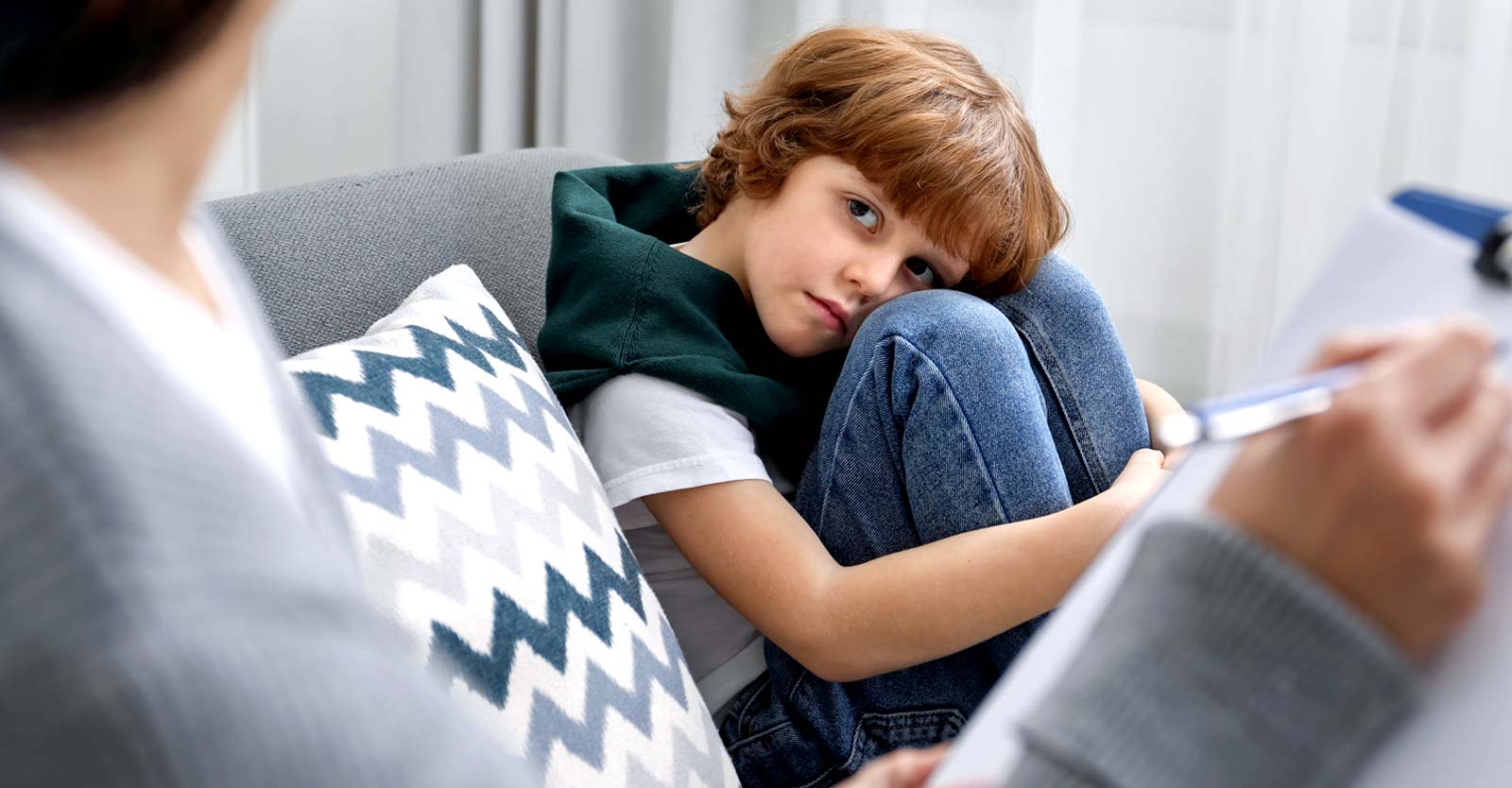 child being screened by adult taking notes