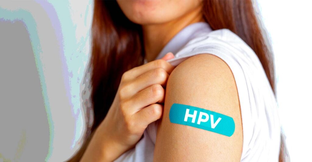 woman with bandage that has "HPV" on it