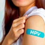woman with bandage that has "HPV" on it