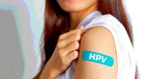 woman with bandage that has "HPV" on it