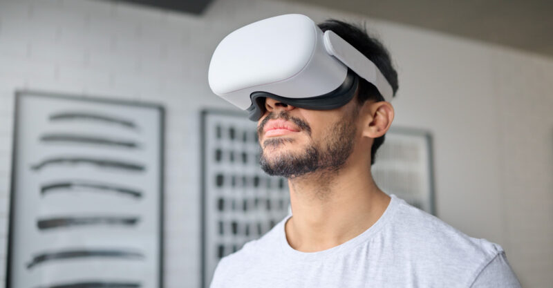 Photo of and man in home with Virtual reality headset.