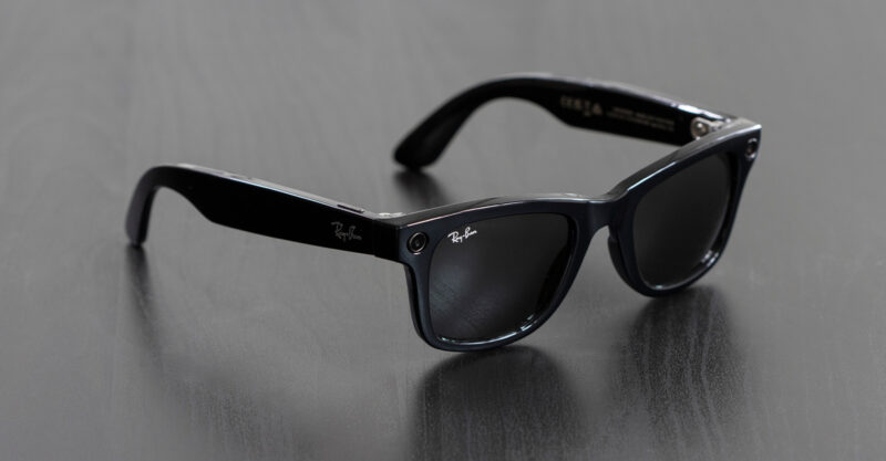A pair of new Ray-Ban Meta Wayfarer smart glasses isolated on a dark gray background.