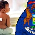 baby at doctor and michigan flag
