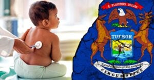 baby at doctor and michigan flag