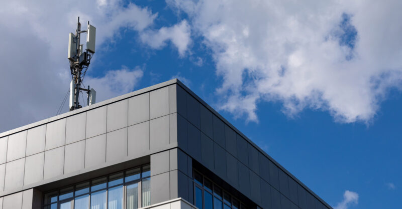 Photo of 5g cell antenna on top of office building.