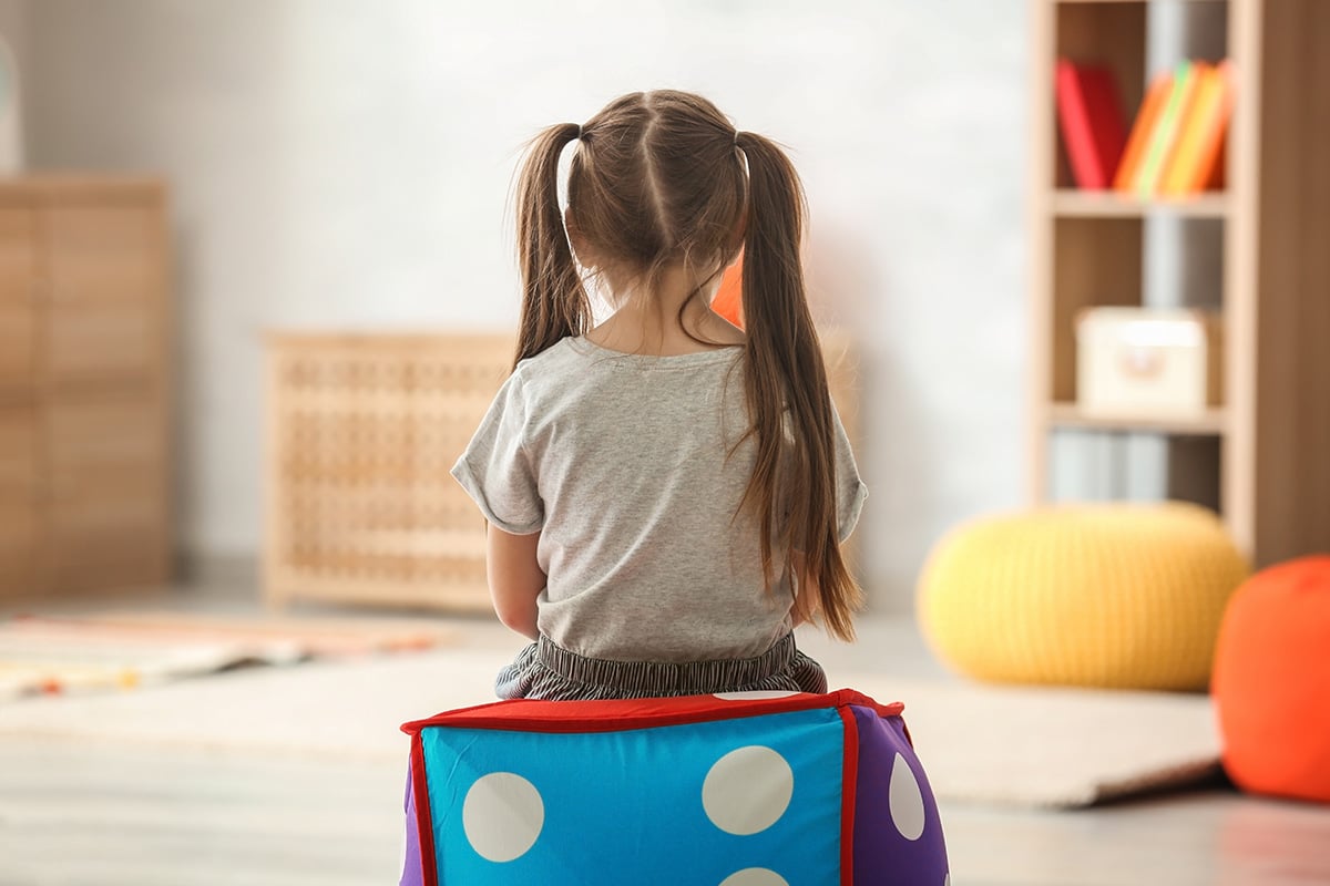 Lonely little girl at home. Autism concept.