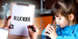 child drinking water, doctor with clipboard and word "fluoride"