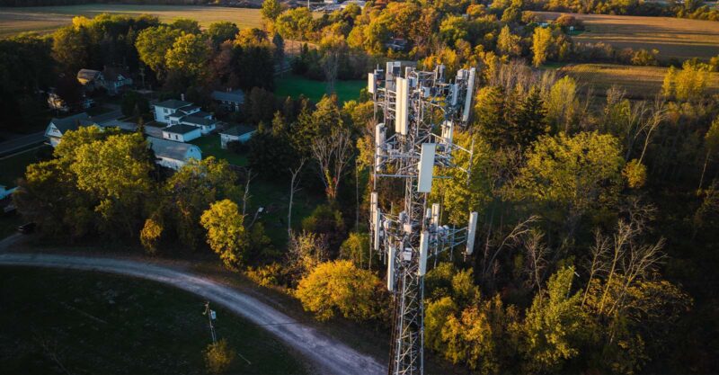 Cell tower across from homes in rural setting.