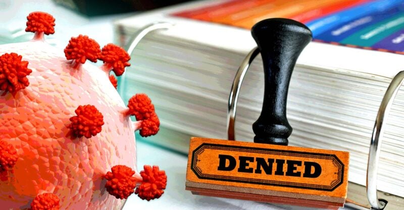 covid spike protein and word "denied" on stamp