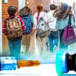 kids in school and vaccine bottle
