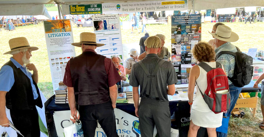people looking at CHD Penn. chapter table at event