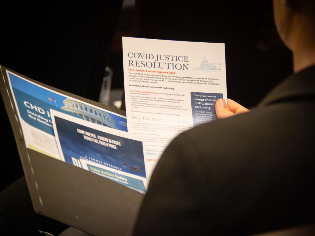 Person looking through folder of brochures