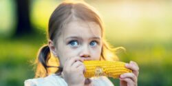 girl eating corn on the cobb