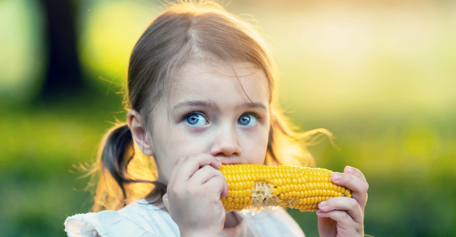 girl eating corn on the cobb
