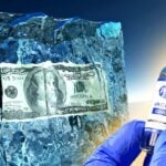 money in frozen ice and pfizer covid vaccine bottle