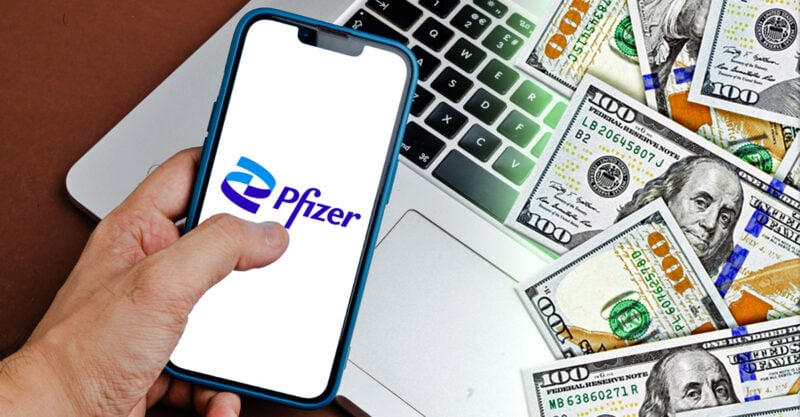 pfizer logo on phone with money