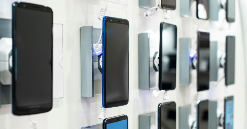 Photo of different smart phones on a wall display.