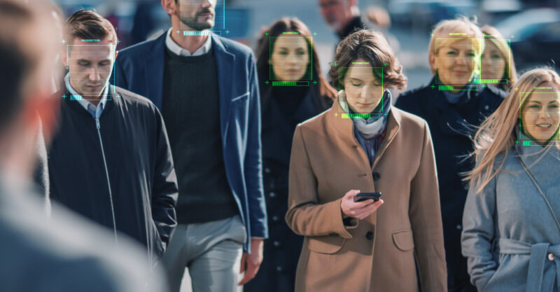 Crowd of Business People Tracked with Technology Walking on Busy Urban City Streets. CCTV AI Facial Recognition.