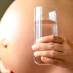 pregnant woman with glass of water