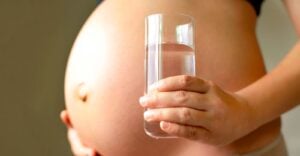 pregnant woman with glass of water