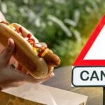 hotdog and warning symbol with word "cancer"