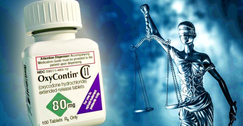 oxycontin bottle and lady justice