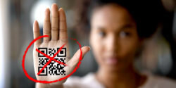 woman holding hand out with qr code and x on it