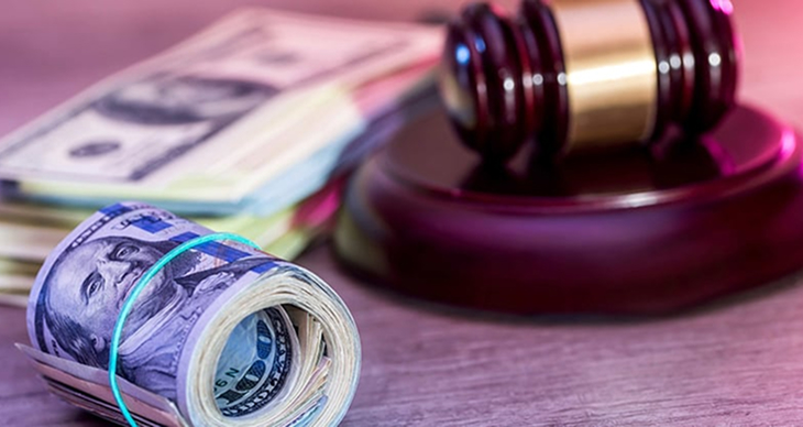 Roll of money next to gavel