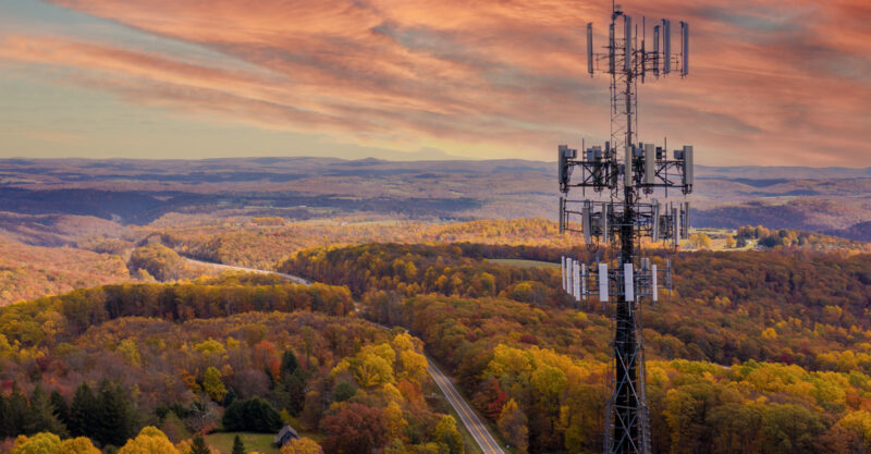 Aerial view of mobile phone cell tower over forested rural area of West Virginia.