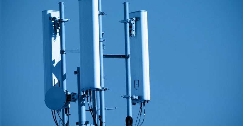 Cell tower radios mounted on small tower on building