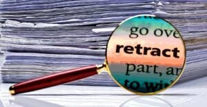 word "Retract" with papers