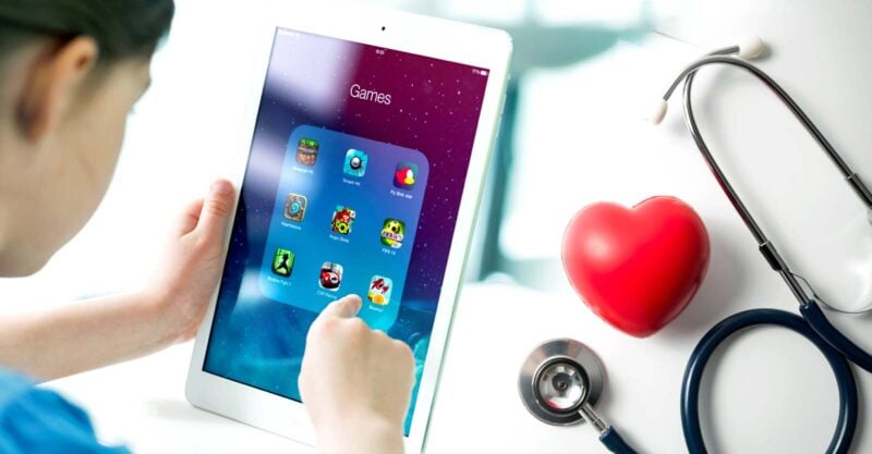 child using iPad and heart