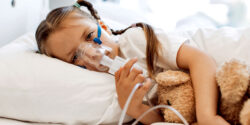 girl with asthma breathing treatment