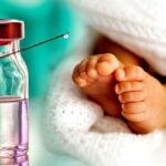 baby feet and vaccine bottle