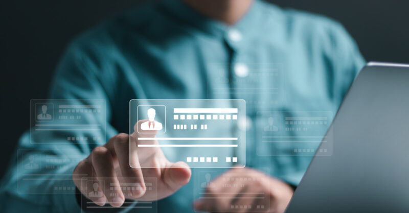Digital identification or digital ID concept. Man using laptop and hand touch virtual screen of digital identification card.
