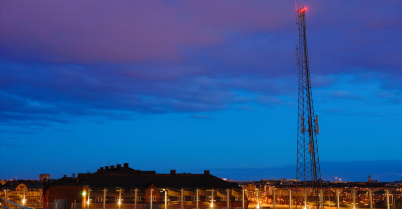 Stockholm, Sweden A mobile phone antenna at night over the city.