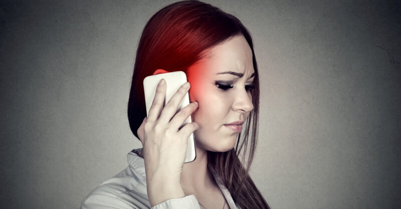 Woman holding cell phone to her head.